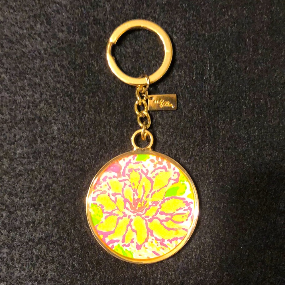 Lilly floral keychain. Gold metal. Green back.